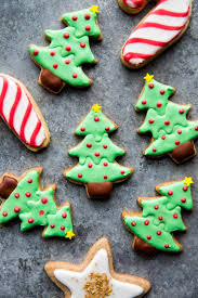 Cropped view of woman holding baked christmas tree cookie in hands with merry christmas illustration. How To Decorate Sugar Cookies Sally S Baking Addiction