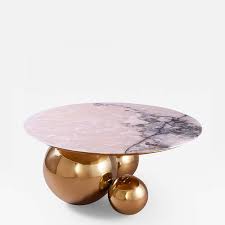 An exquisite piece of jewelry from an ancient queen's collection was the muse for this hammered brass table, featuring a tabletop of natural quartz in stunning shades of rose. Studio Mvw Jinshi Pink Jade Coffee Table