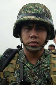 A Philippine marine waits for a landing craft, air
