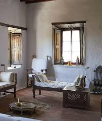 The sitting room's antique patmian bench is flanked by john stefanidis photophores and a yellow table by the designer; Designer John Stefanidis And Artist Teddy Millington Drake S House On Patmos Greece