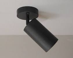 My guess is to use a screwdriver and pry the fixture off the ceiling (i am assuming springs hold it up), but am afraid to break it. Blackened Brass Cylinder Ceiling Spot Light Bullet Light Mid Century Solid Brass Light Flush Ceiling Mount Light Bra Cylinder Lights Can Lights Led Bulb