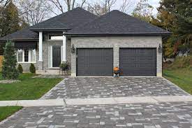Your Garage Door Is One Of The Hardest Working Parts In Your Home It Is The Largest Moving Part In Your Brick House Colors Brick Exterior House Exterior Brick