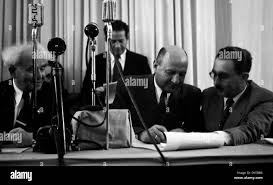 May 15th 1948. Israel declares independence. Left to right David Ben  Gurion, Moshe Kaplan and Moshe Sharett sign the declaration Stock Photo