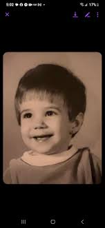 Who is the person in the childhood photo?