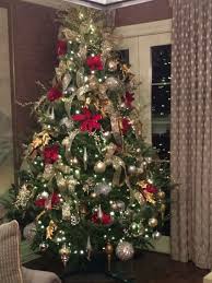 Silver and gold ribbon and silver and gold balls, garland, and ribbon bow tree topper. Silver And Gold With Pop Of Red Christmas Tree Christmas Tree Inspiration Red Christmas Tree Classic Christmas Tree