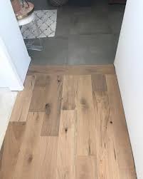 Wood Floors Are Underway W A Sleek Transition To Concrete Style Tiles Tile To Wood Transition Flooring Style Tile