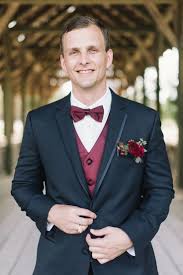 Black And Maroon Tuxedo Meet Our New Favorite Suit Accessory The Pocket Boutonniere Love Inc Mag Maroon Wedding Suit Wedding Suits Men Wedding Suits