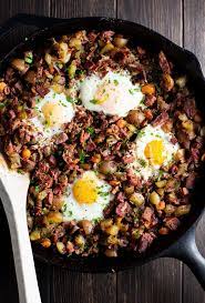 A casserole of cubed rye bread, shredded corned beef, sauerkraut and swiss cheese finished with a savory egg custard. Corned Beef Hash And Eggs Recipe Kitchen Swagger