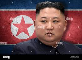 Kim Jong-un and North Korean flag Stock Photo