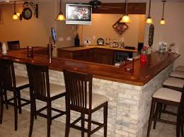 A mix of natural materials — stone columns, marble countertop, leather barstools and richly finished wood — makes this basement bar a showpiece. So Glad Our New House Has A Big Brick Bar In The Basement But We Ll Be Painting It Cream Brick Bar Home Decor Home Remodeling