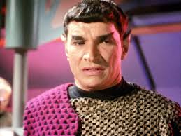 Romulan Commander and Sarek could be twins. Out of universe answer is that  Mark Lenard played both roles. In universe answer is the possibility that  they're distantly related. Perhaps an ancestor of