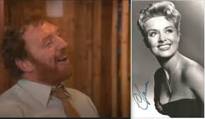 Gary Holton posing alongside the rather iconic early 80s Tory campaign  poster 'Labour Isn't Working' for the opening titles of Auf Wiedersehen Pet  series one.