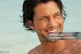 Man At The Beach With Sand On His Face High-Res Stock Photo