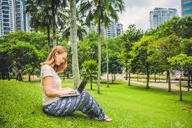 Click your profile picture, then click settings.; A Young Woman In Casual Dress Using Laptop In A Tropical Park Stock Photo Picture And Royalty Free Image Image 73279954