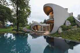 The style is mostly minimalism with clean lines. Organic Meets Futuristic Architectural Design House In The Landscape