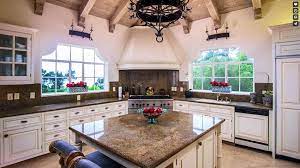 The kitchen island features black and white granite countertops with a dark wood casework base, similar to that of the curved breakfast bar with studded white leather upholstery. 30 Antique White Kitchen Cabinets Design Photos Designing Idea