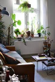Vintage interior styling focuses on minimal clutter and puts forth a very clean, crisp, and classy display of furniture, decorative accents, and designs. Serene And Plant Filled Living Room Happy Interior Blog