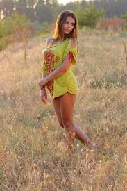 woman in yellow red floral one shoulder shirt standing on brown grass during daytime fashion girl images fashion beautiful girl photo