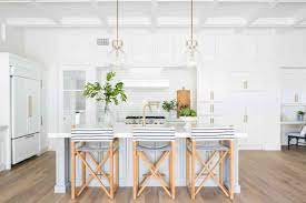 This beach themed interior design kitchen dining area is stunning with its full height window that runs the length of the room overlooking the adjacent beach. Coastal Kitchen Ideas