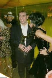 Prince andrew raises a slight smirk as he poses next to a mysterious blonde clad in a feather headdress and mask. 19 Epstein Ideas Prince Andrew Duke Of York Duchess Of York