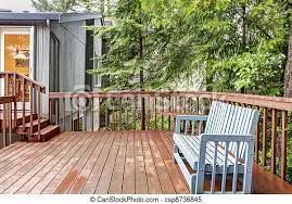 This cozy lake cottage skillfully incorporates a number of features that would normally be restricted to a larger home design. Back Of The House Deck With Blue Bench Small Deck With Blue Chair And Grey House Canstock