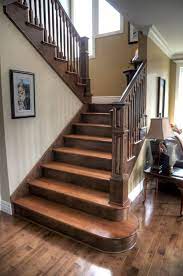 The angular railing is the quintessential element for many modern staircases. Two Tone Staircase With Custom Posts Railing Stairs Stained Staircase Staircase Design Rustic Stairs