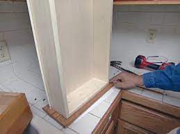 Refacing kitchen cabinet doors is really just a matter of switching out the doors after covering all the exposed parts of the frame with veneer that matches the new finish. How To Reface And Refinish Kitchen Cabinets How Tos Diy