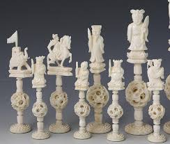 Chinese puzzle balls are ornate decorative items that consist of several concentric spheres, each of which rotates freely, carved from the same piece of material. Lot Chinese Carved Ivory Puzzle Ball Chess Set