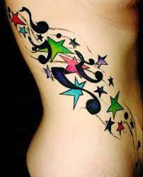 Here is the picture for better understanding. Music Notes And Color Star Tattoos On Side Rib