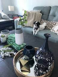 A beautifully decorated coffee table in a living room is always a centerpiece. Coffee Table Decor Ideas Guide Ashley Homestore Living Room Decor Cozy Vases Decor Living Room Decorating Coffee Tables
