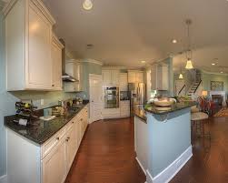 The accessories, like the red kettle, make the room pop and transform the kitchen from an ordinary space to one with a bright, youthful look. Kitchen Love The Light Cabinets Wall Color And Dark Counters Kitchen Colour Schemes Kitchen Remodel Kitchen Paint