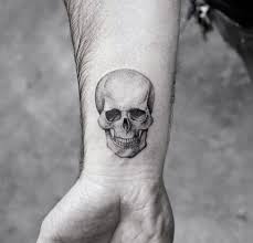 Realistic Human Skull Done In Black And Grey Ink On A Man S Wrist Small Symbolic Tattoos Memen Wrist Tattoos For Guys Small Skull Tattoo Small Tattoos For Guys