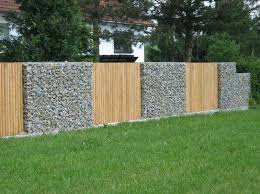 Gabion Fence With Vertical Timber Pailings Http Www Gabion1 Com Gabion Fence Rock Wall Gardens Gabion Wall