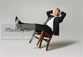 The person leans back and folds his/her arms behind the head openly. Lean Back Chair