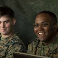U.S. Army COL. Dick Pedersen (center, rear, black holster), Commander, 3rd  Brigade, 25th Infantry Division (Light), presents a Combat Unit Patch to  one of his Soldiers at Kandahar Airfield, Afghanistan,