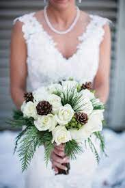 While this clutch predominantly featured brown flowers (rose and protea are both seen here), subtle hints of blue delphinium added softness and contrast. Really Beautiful For A Winter Wedding Winter Wedding Flowers Winter Wedding Bouquet Winter Bridal Bouquets