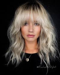 The deep side bangs and straight layers make this hairstyle the perfect emo look for blonde locks. Voluminous Blonde Layered Lob With Face Framing Fringe And Messy Wavy Texture The Latest Hairstyles For Men And Women 2020 Hairstyleology