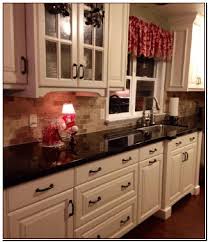 Black Countertops With Dark Brown Cabinets Black Countertops With Dark Bro In 2020 Antique White Kitchen Cabinets Antique White Kitchen Kitchen Without Backsplash