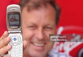 Tom Alexander, chief executive of Virgin Mobile poses with a mobile... News  Photo