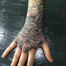 A black and gold floral inspired design is rendered on the wearer's ankle, shin, and foot in this tattoo. 175 Small Hand Tattoo Ideas Ultimate Guide July 2021