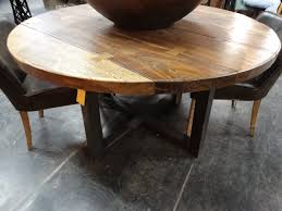 In., the table can fit two comfortably or four in a pinch for some drinks under the sun. Wood And Iron Dining Table Features A Wood Top And A Black Metal Base