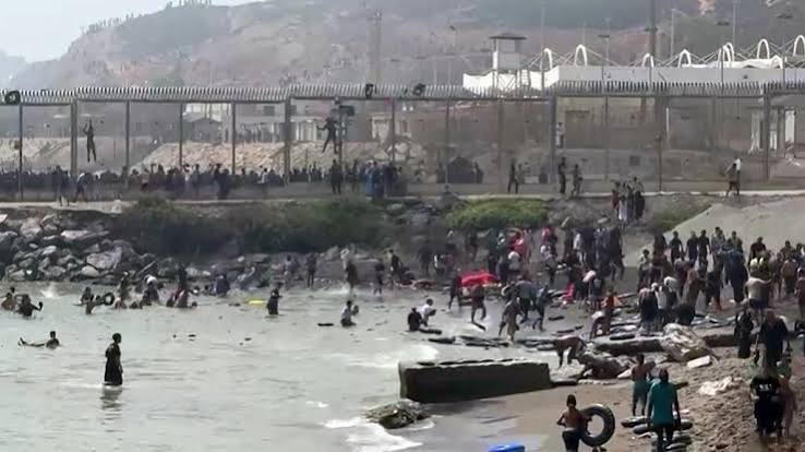 Migrants arriving at the beach in Ceuta after swimming across the border from Morocco.