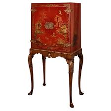Chinese red lacquer cabinet with 2 drawers and 2 doors. Red Lacquer Cabinet On Walnut Parcel Gilt Stand