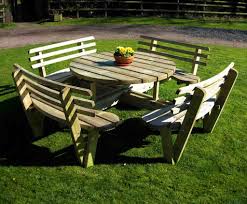 Named for the act of eating meals outdoors, or picnicking, picnic tables are found in many public parks, campgrounds, and rest areas, but their functional design has also made them popular for cafeterias, community centers, and break rooms. Circular Picnic Table With Back Rests Wooden Garden And Patio Furniture