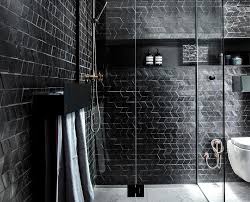 A Moody Bathroom With Black Tiles Black Tiles Black Tile Bathrooms Sophisticated Bathroom