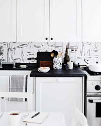 Sebring design build for more modern kitchen designs, choosing two contrasting tones can create a striking color scheme.this kitchen features bright white cabinets with a dramatic charcoal grey stacked stone backsplash. Hand Painted Tile Backsplash Martha Stewart
