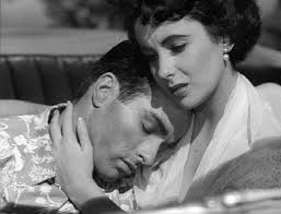 Angela Vickers (Elizabeth Taylor) comforts her boyfriend George Eastman  (Montgomery Clift) when he learns his ex-girlfriend Alice Tripp (Shelly  Winters) is pregnant in 1951's "A Place in the Sun".