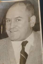 My great grandfather John McGlennon (flat cap) alongside his wife Rose (nee  Maguire) and his two sons, Jimmy (left) and Michael (right). Taken in St  Mary's courtyard (What is now Review in