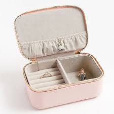 Compact travel jewelry box with storage for 3 sets of earrings, 4 necklaces, and several rings. Blush Jewelry Case Paper Source