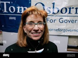 Vicki Powell poses in front of a campaign poster at the campaign  headquarters of Tom Osborne in Lincoln, Neb., Wednesday, Nov. 9, 2005.  Powell, who twice served as former Neb. Gov. Mike